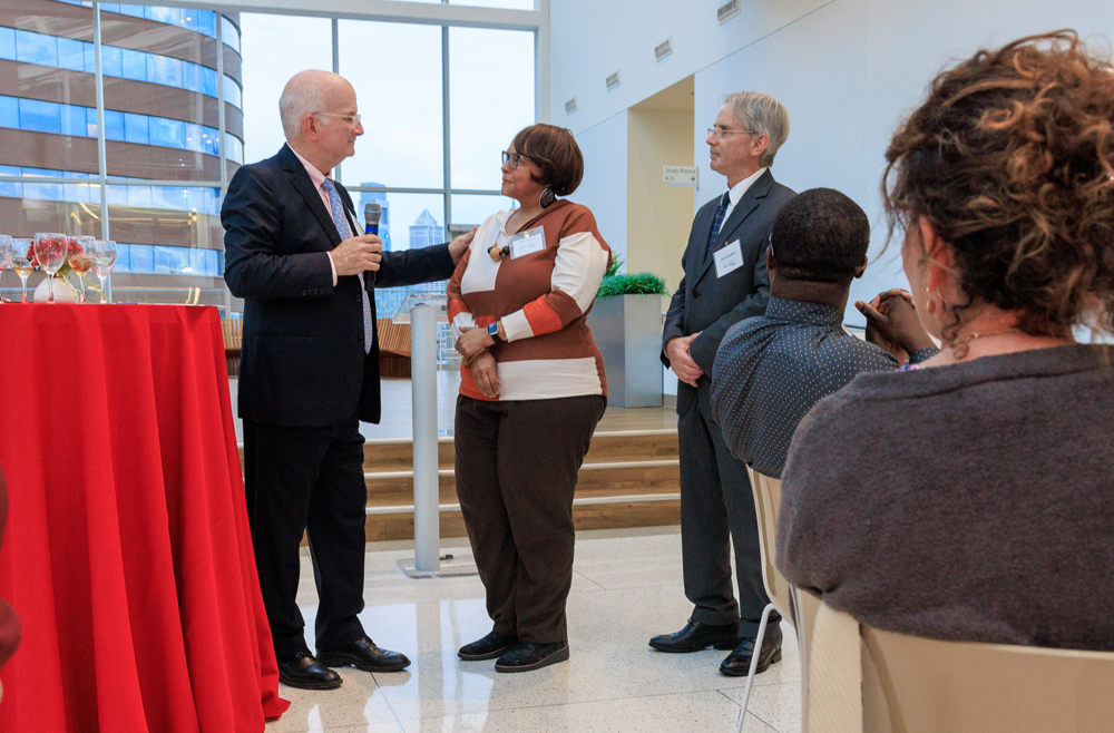 UPHS CEO Kevin Mahoney presents the Community Champion Award to Cheryl Seay as Jonathan Epstein, the interim dean of the Perelman School of Medicine, looks on.